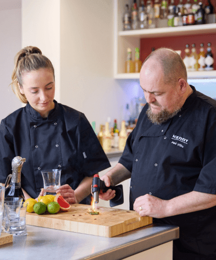 Two chefs demonstrating technique
